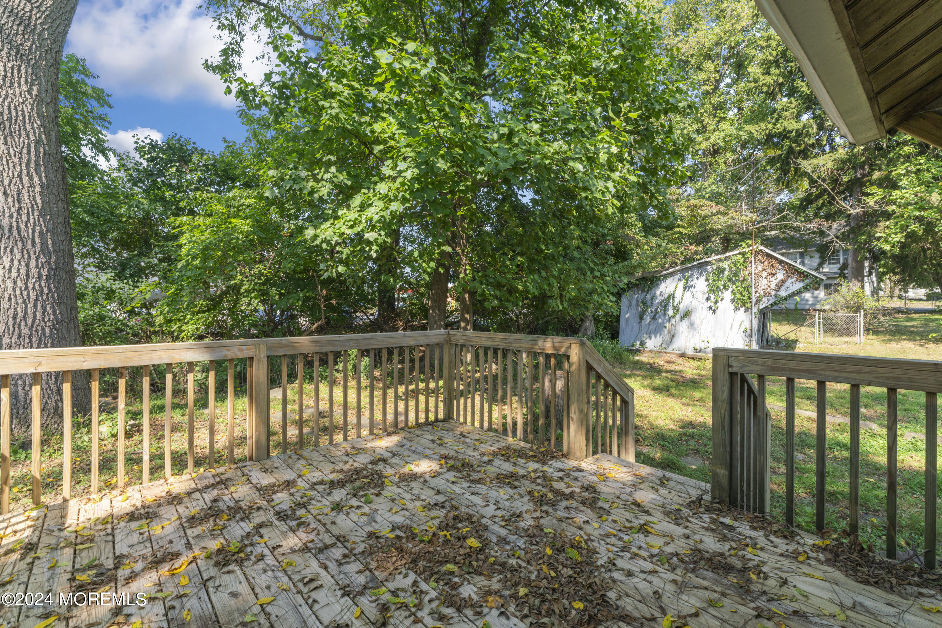 a view of balcony with wooden floor and fence