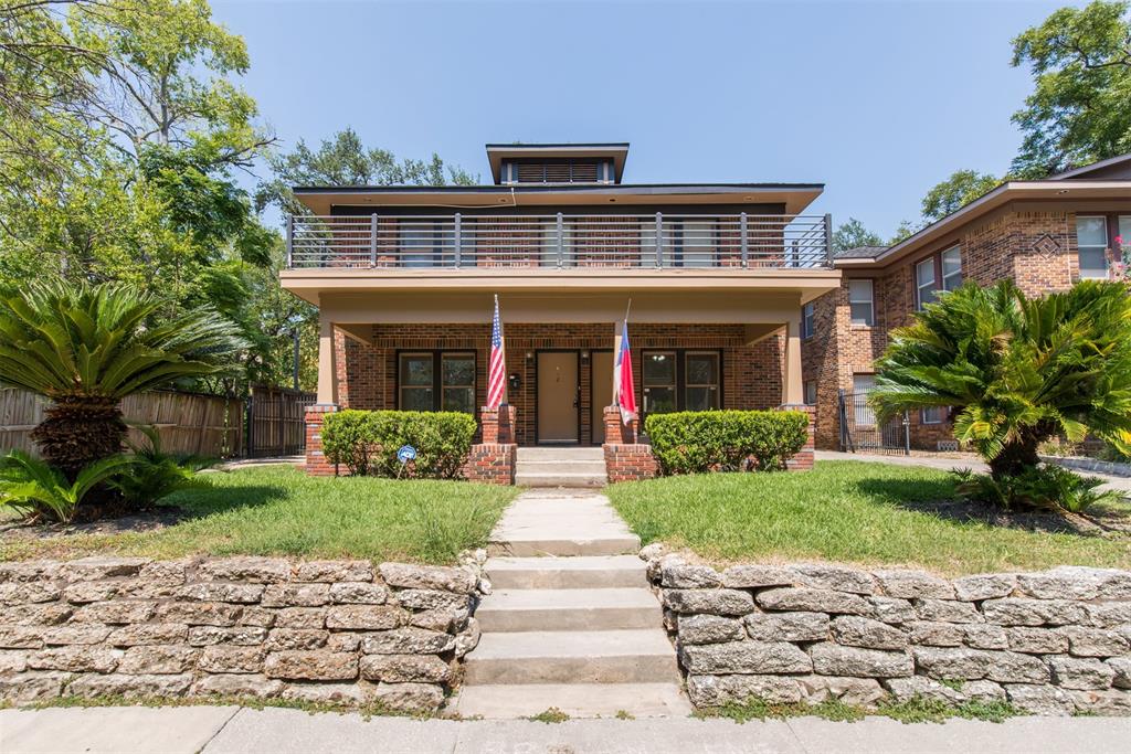 a front view of a house with a garden and plants