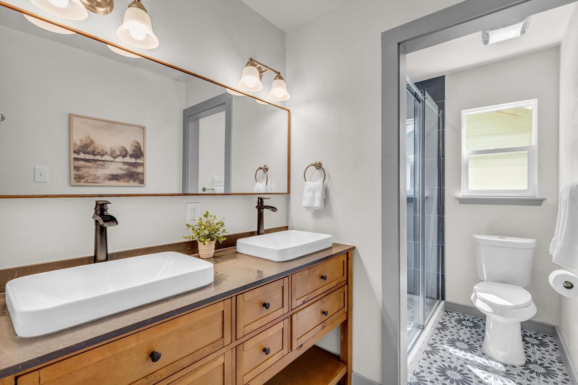 a bathroom with a toilet sink and mirror