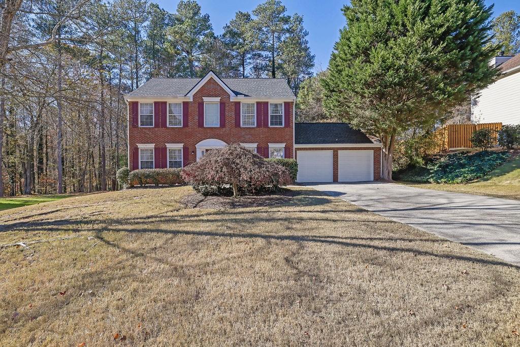 a front view of a house with a yard