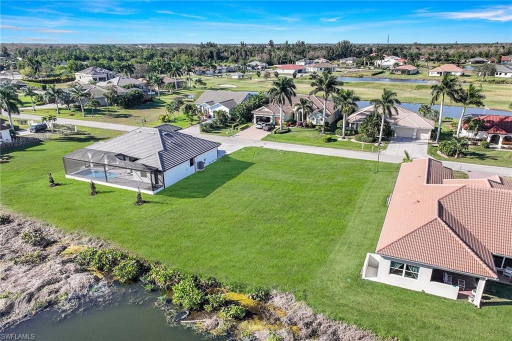 an aerial view of a house with a garden and lake view