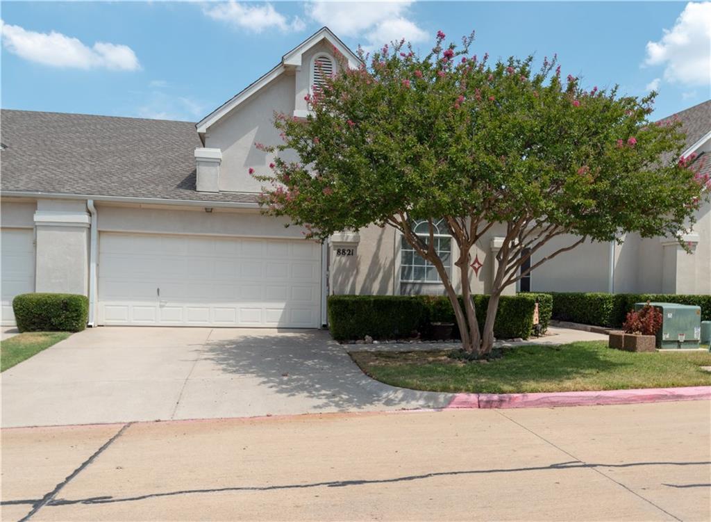 a front view of a house with a yard and a garage