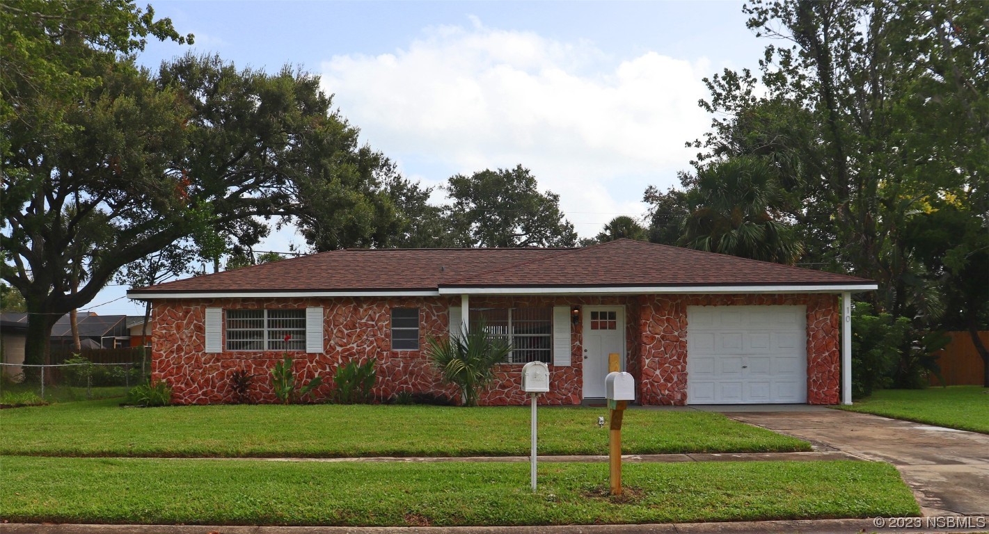 a front view of a house with a garden