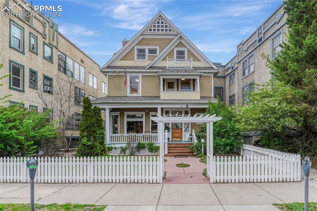 a front view of a house with a fence