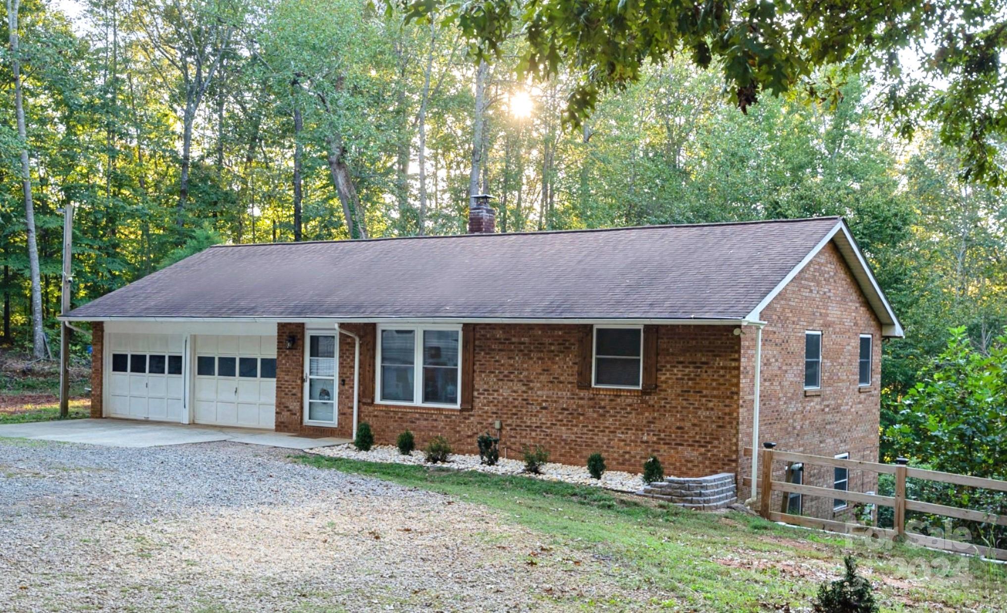 a house that has a tree in front of it