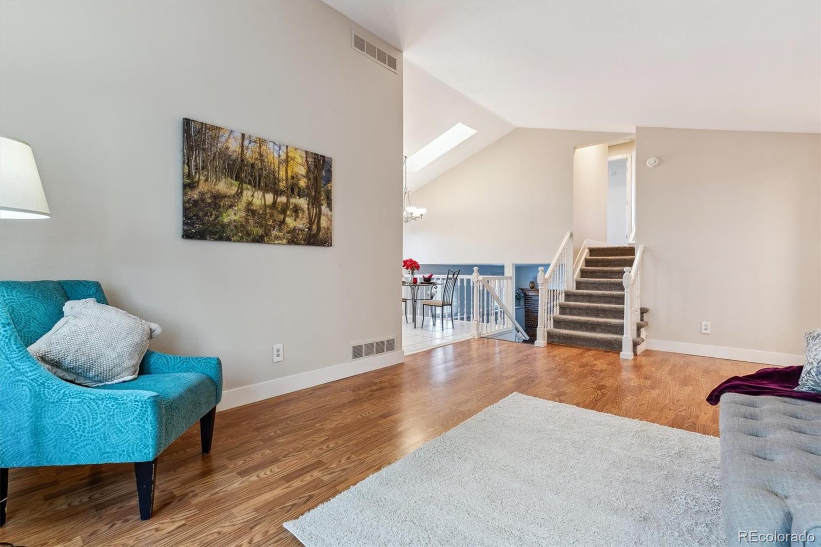 a view of a livingroom with furniture and stairs