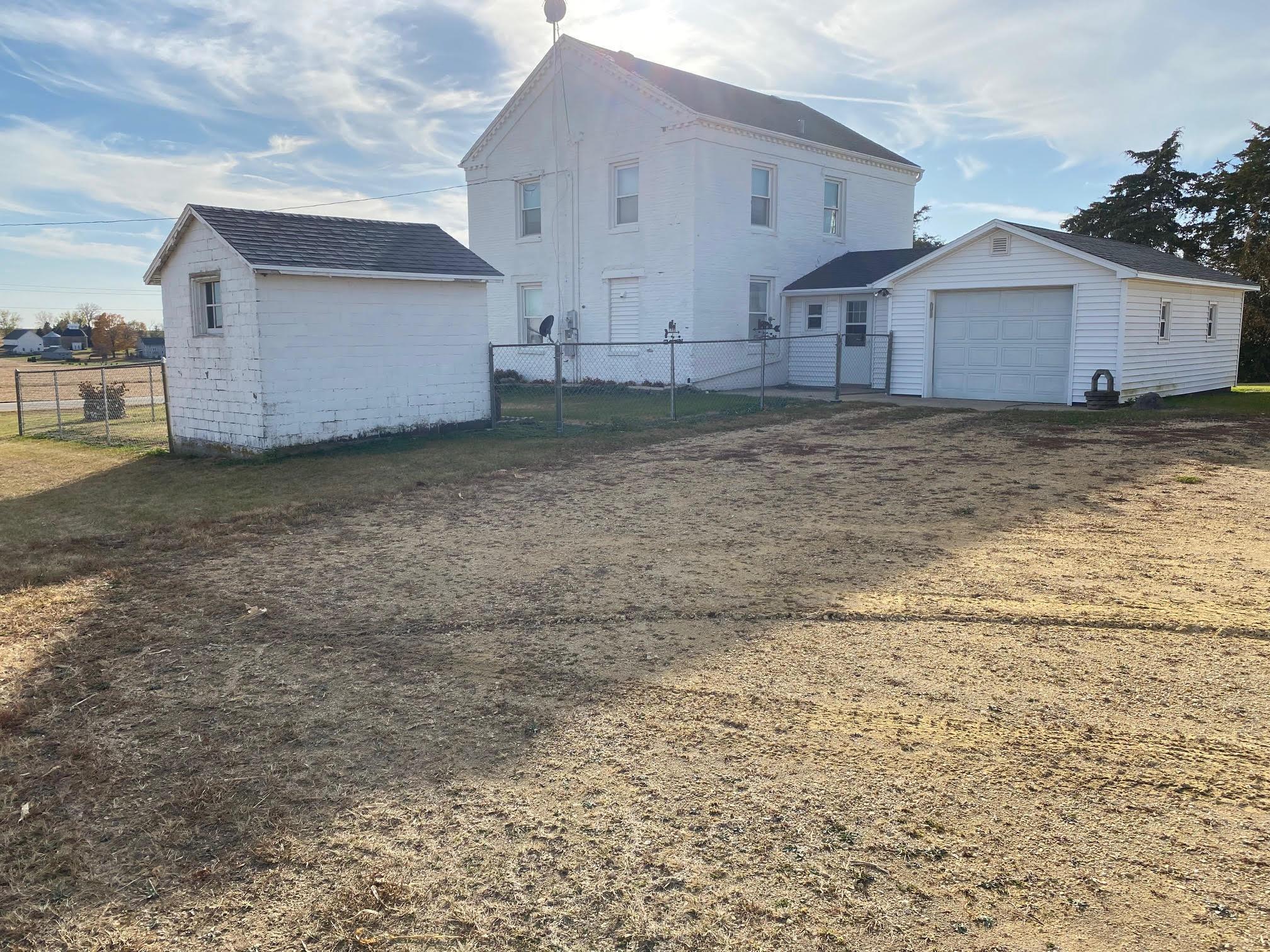 a view of a house with a backyard and a tree