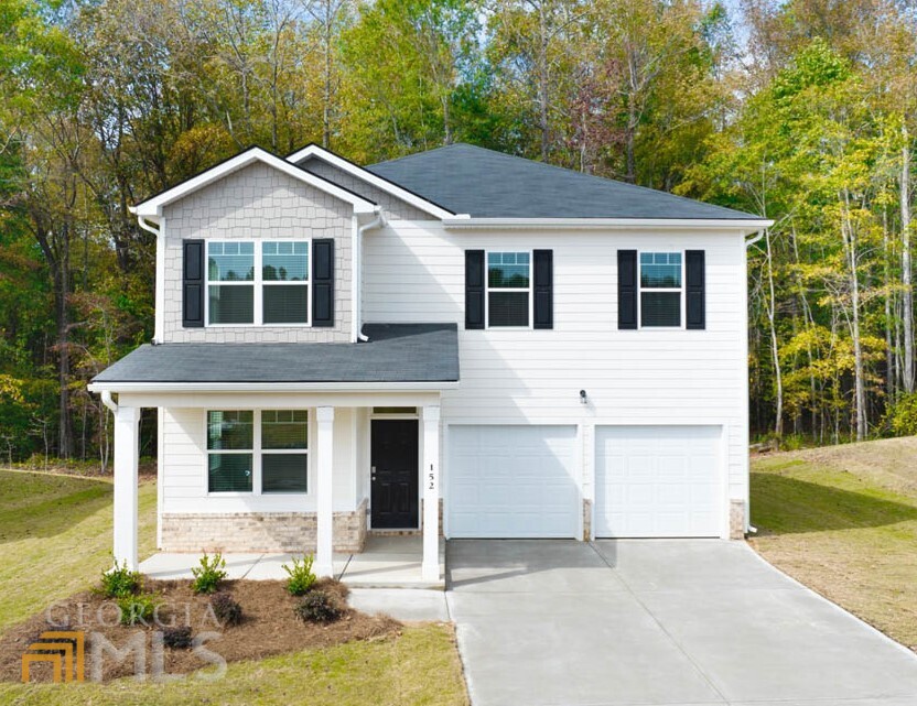 a front view of a house with a yard