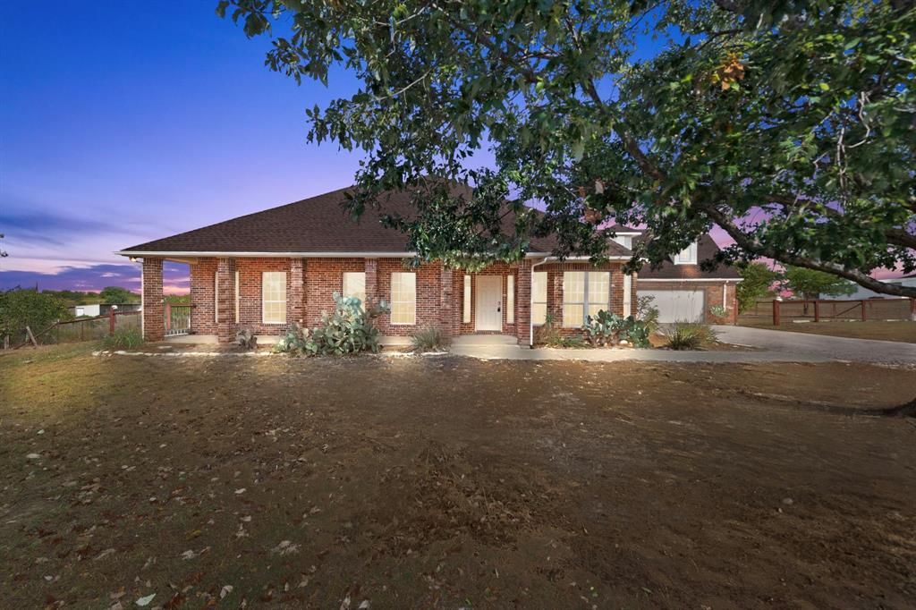 a view of backyard of house with green space