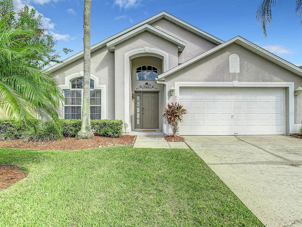 a front view of a house with a yard and garage