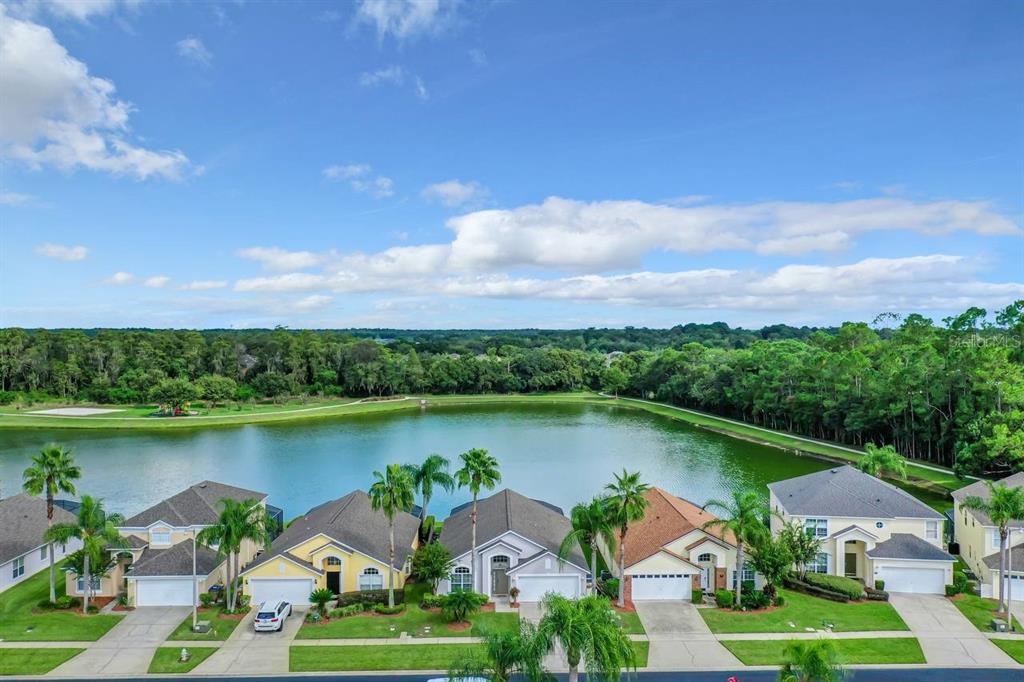 an aerial view of a house with outdoor space lake view and boat