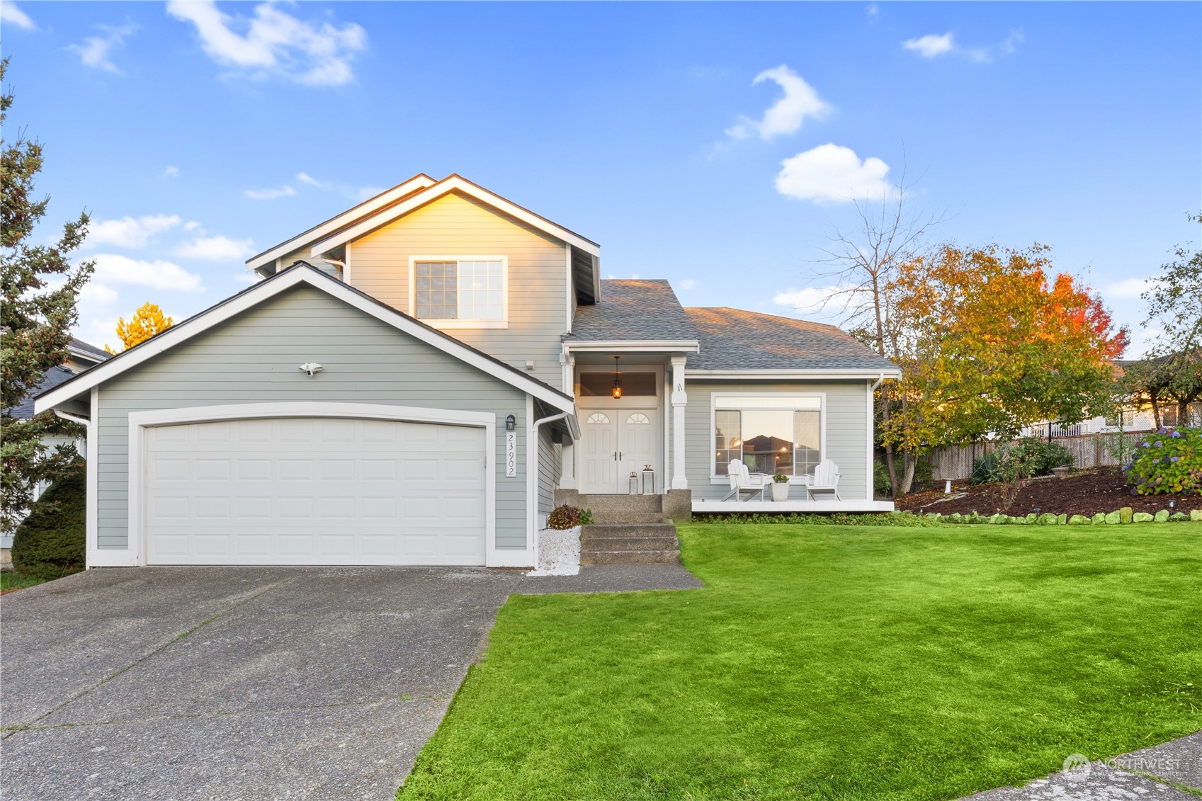 a view of a house with a yard and garage