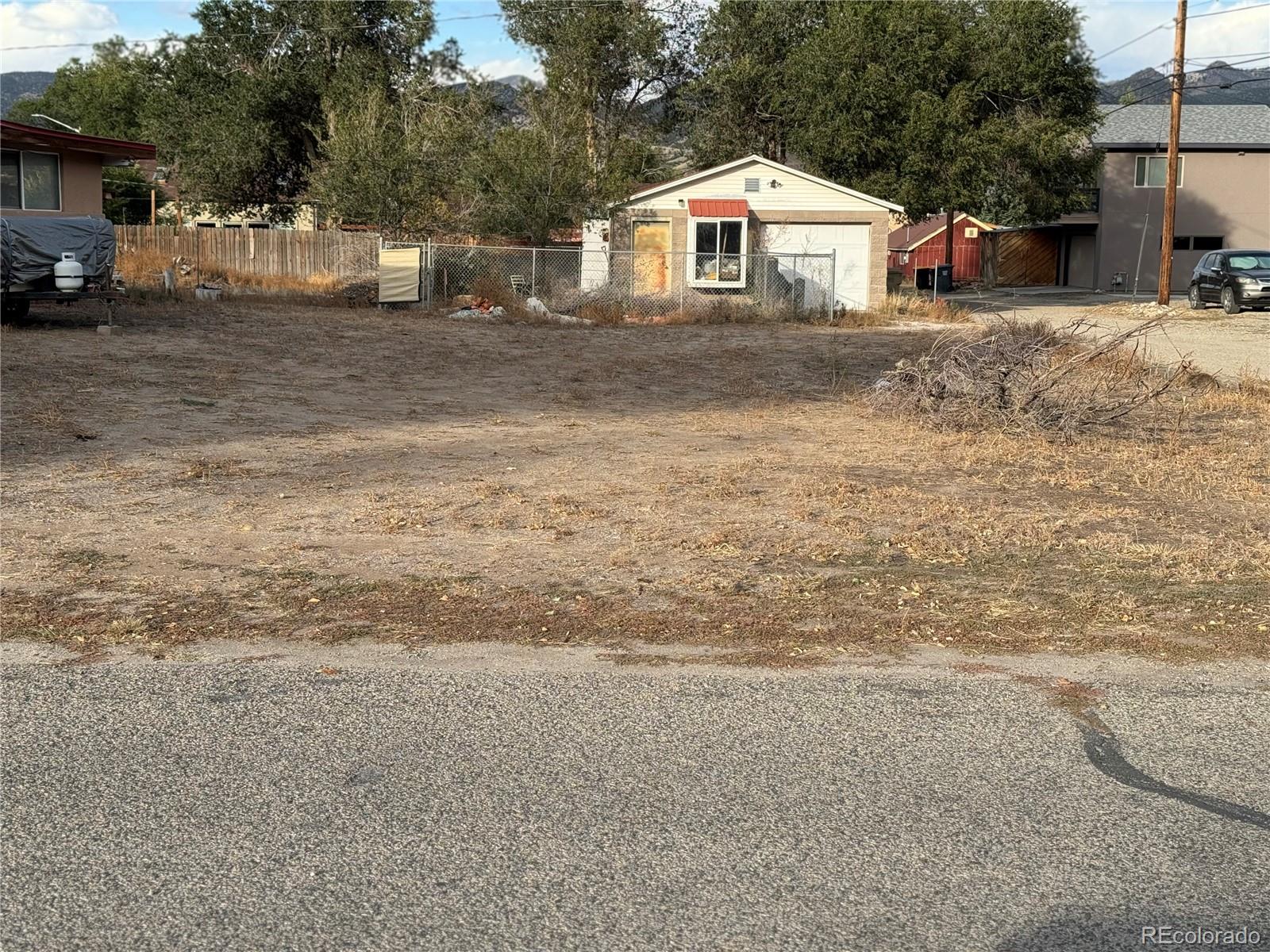 a view of white house with a yard