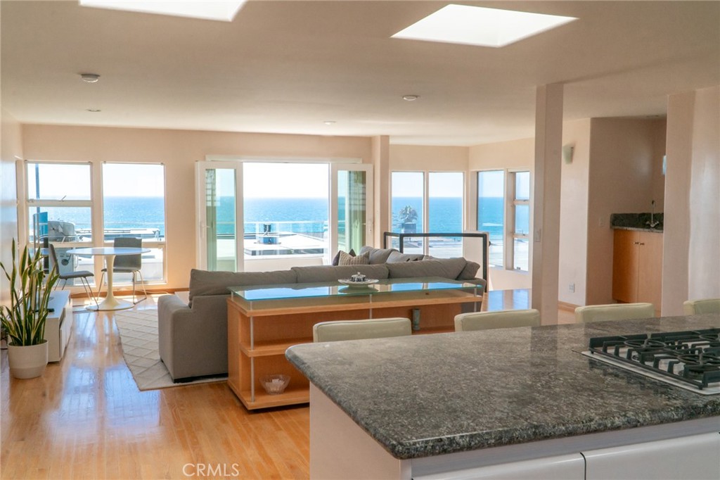 a kitchen with granite countertop a stove and large window