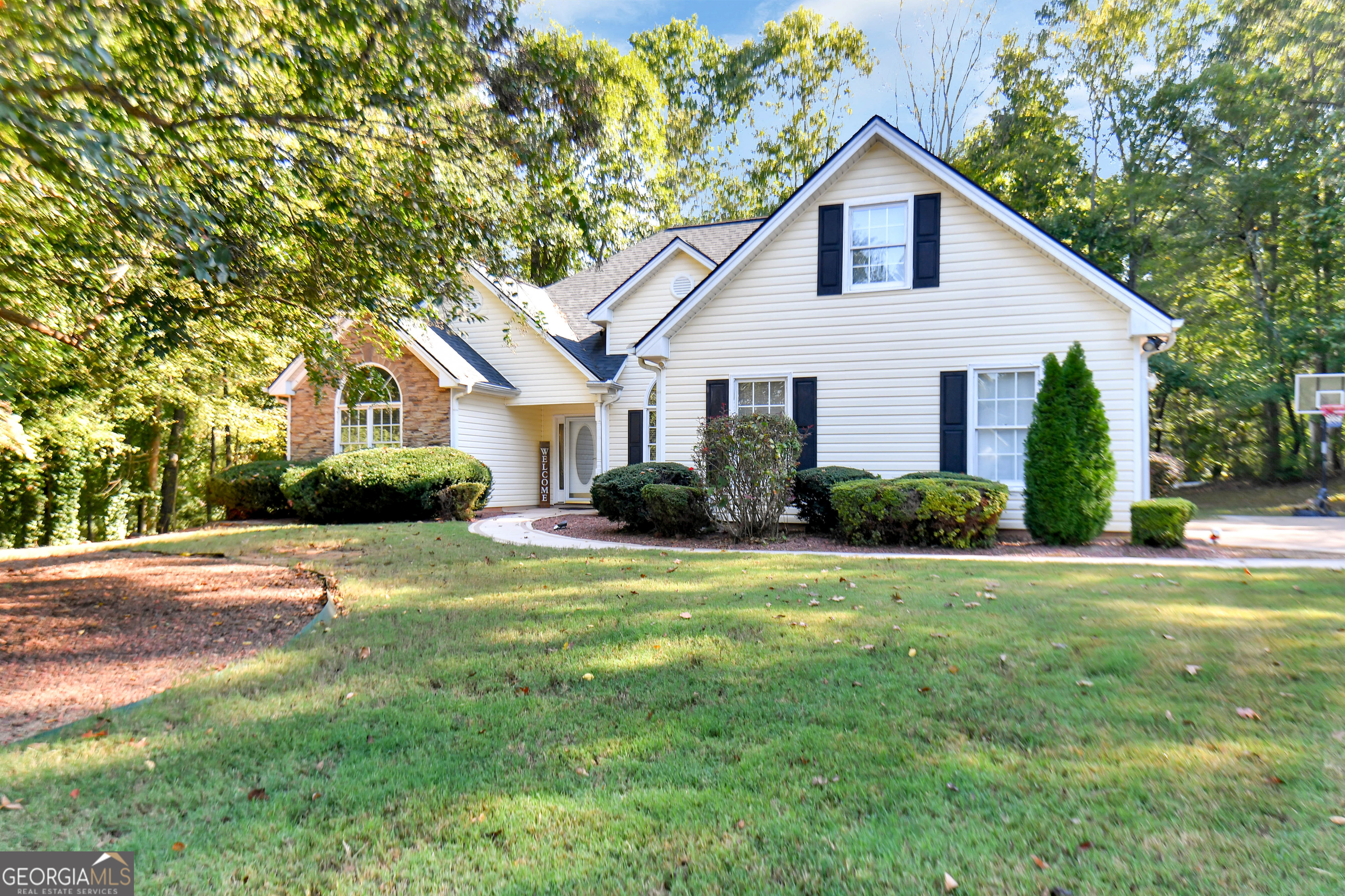 a front view of a house with a yard and garage