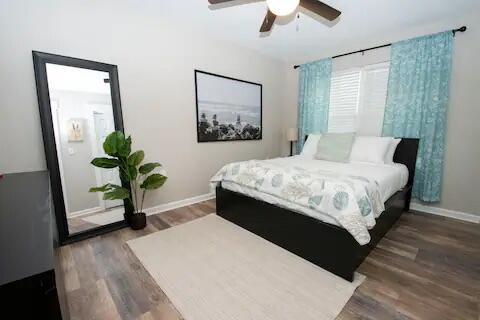 a bedroom with a large bed chandelier and a window