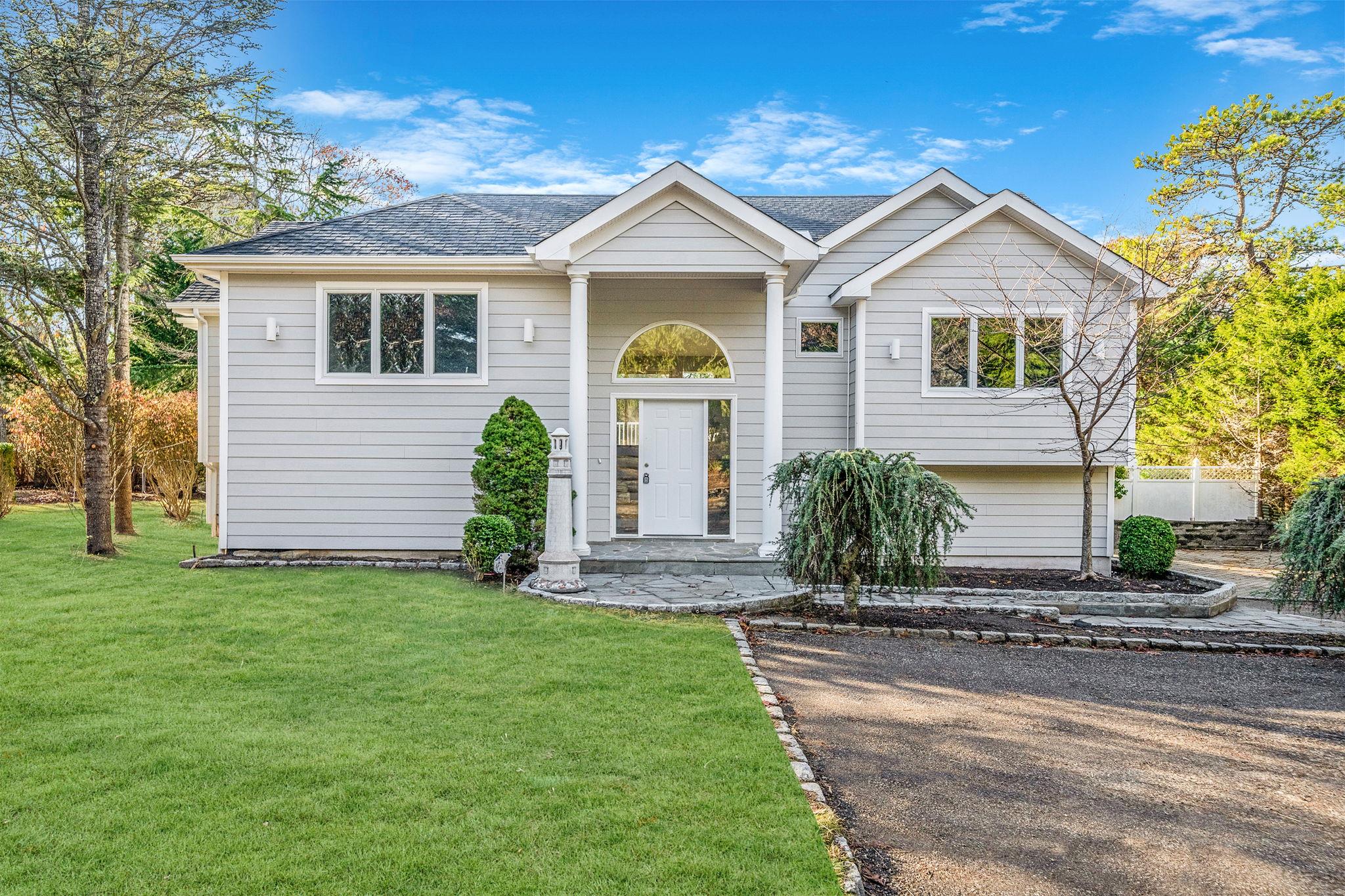 a front view of a house with a yard