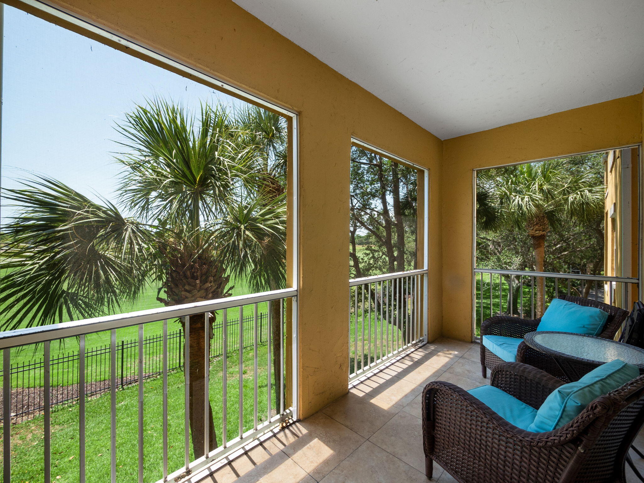 a balcony with furniture and a potted plant