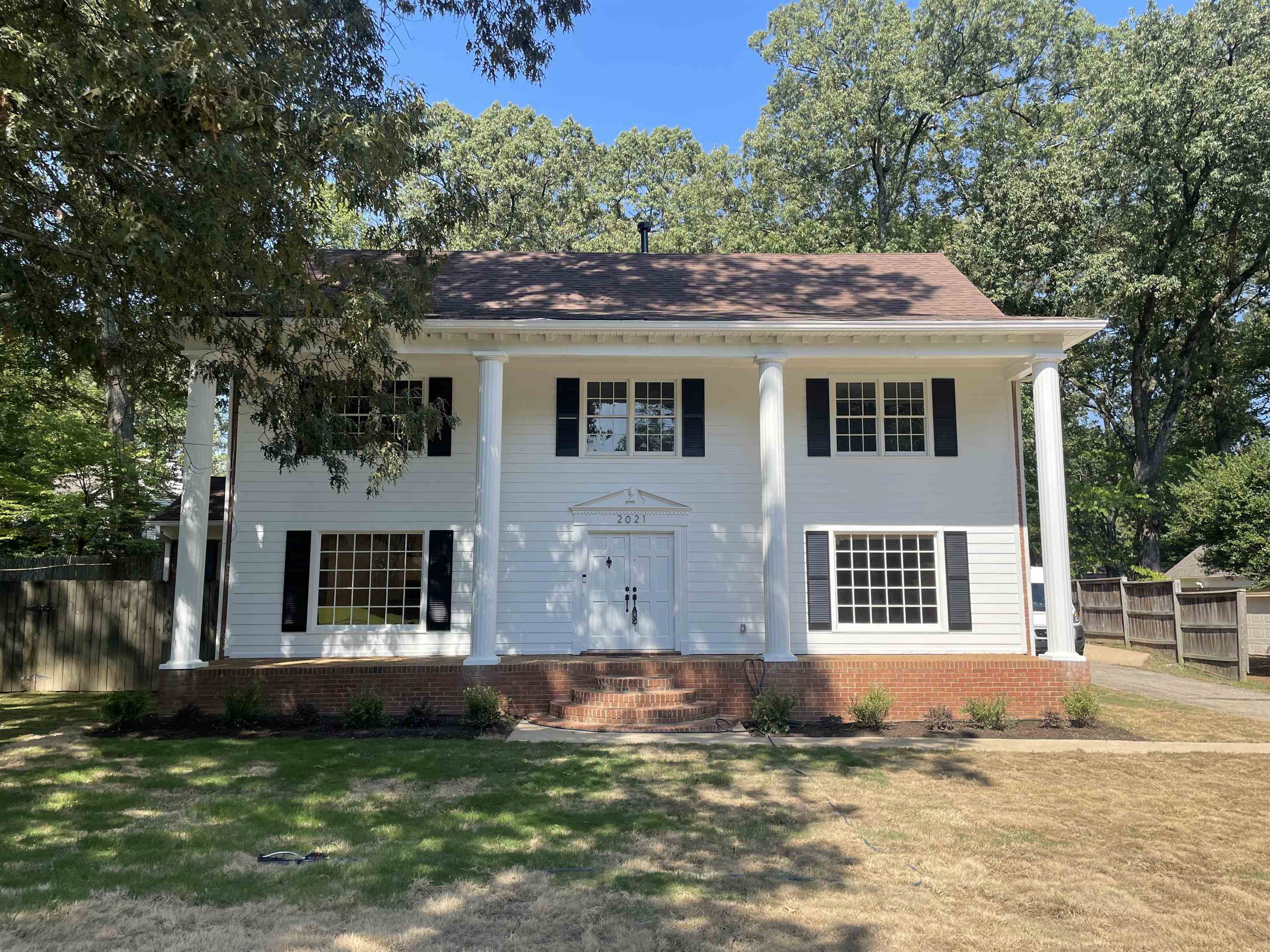 a front view of a house with a garden