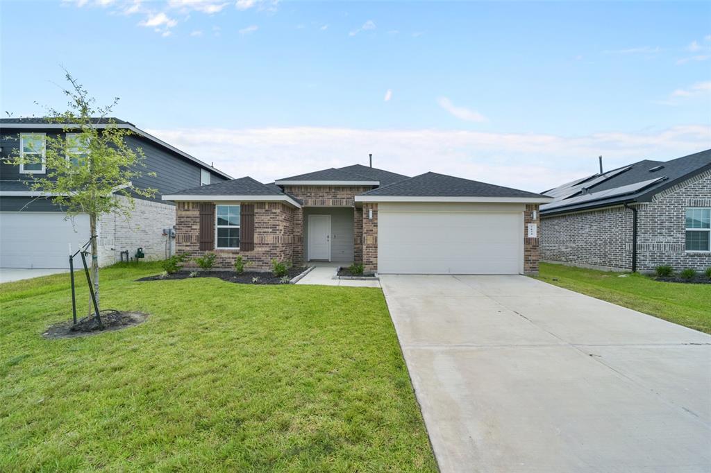 a front view of a house with a yard and garage