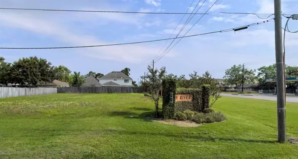 a view of a field with a tree in front of it