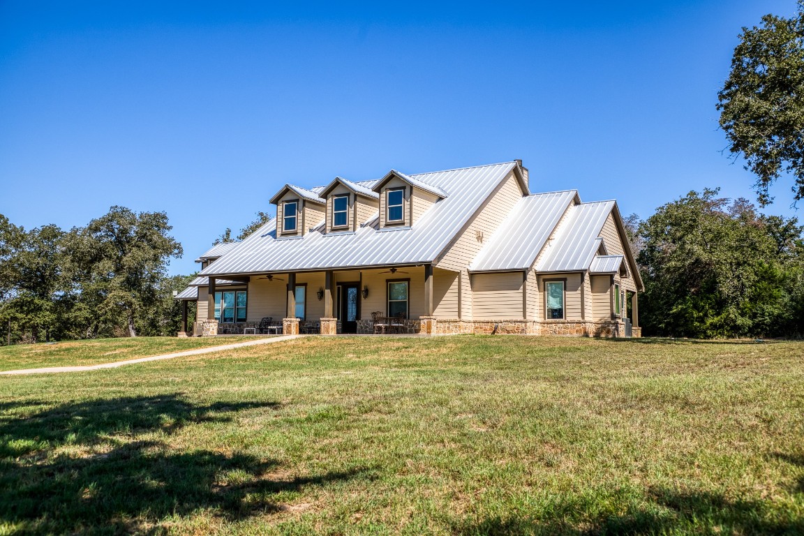 a front view of a house with a garden