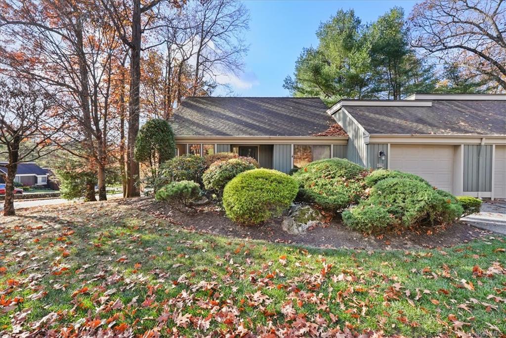 a house that has a tree in front of it