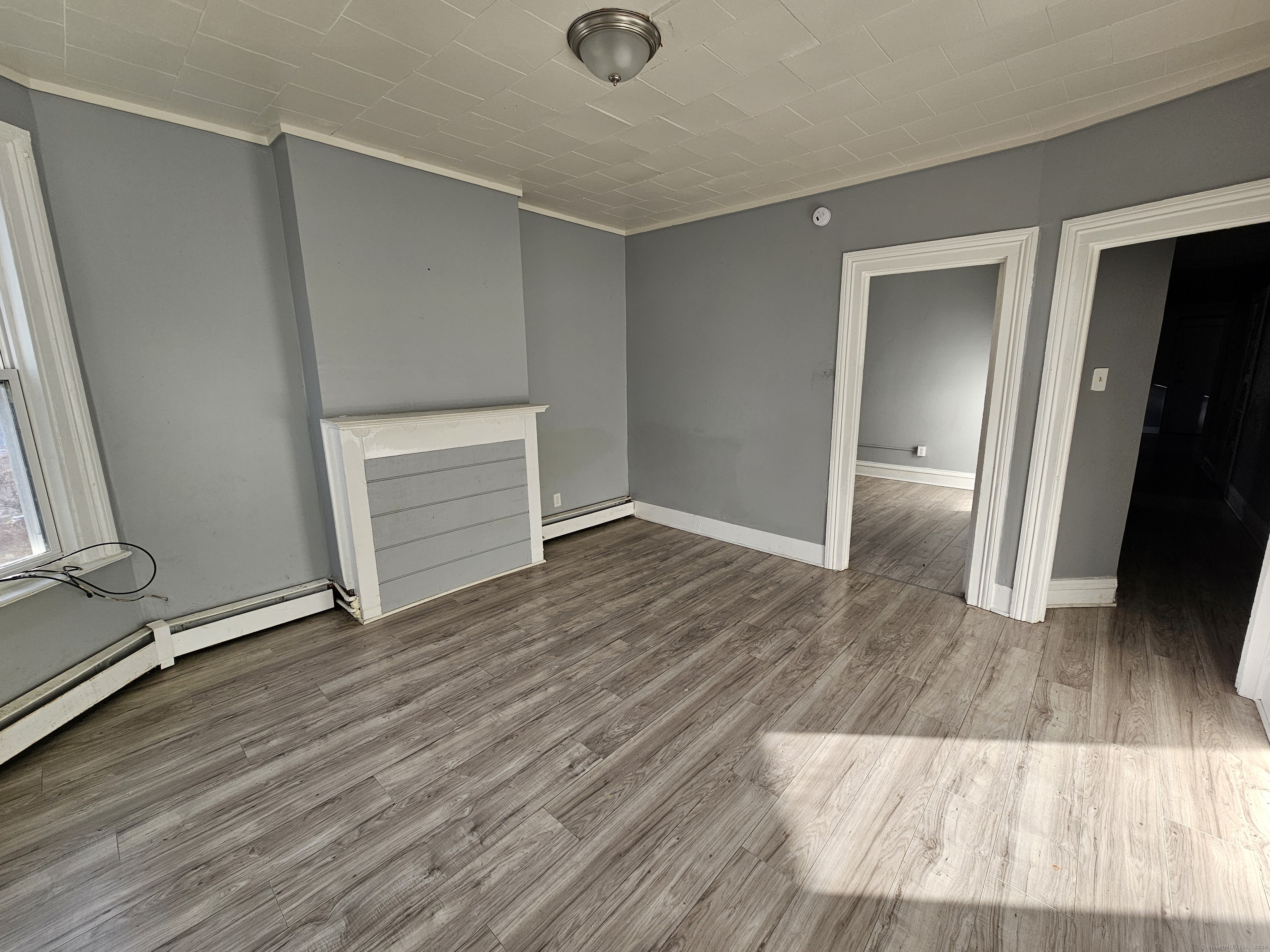 an empty room with wooden floor and closet