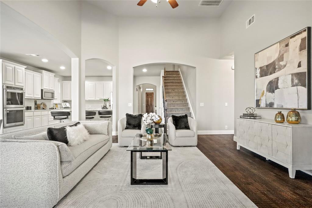 a living room with furniture and kitchen view