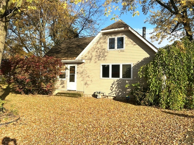 a front view of a house with a yard covered in snow