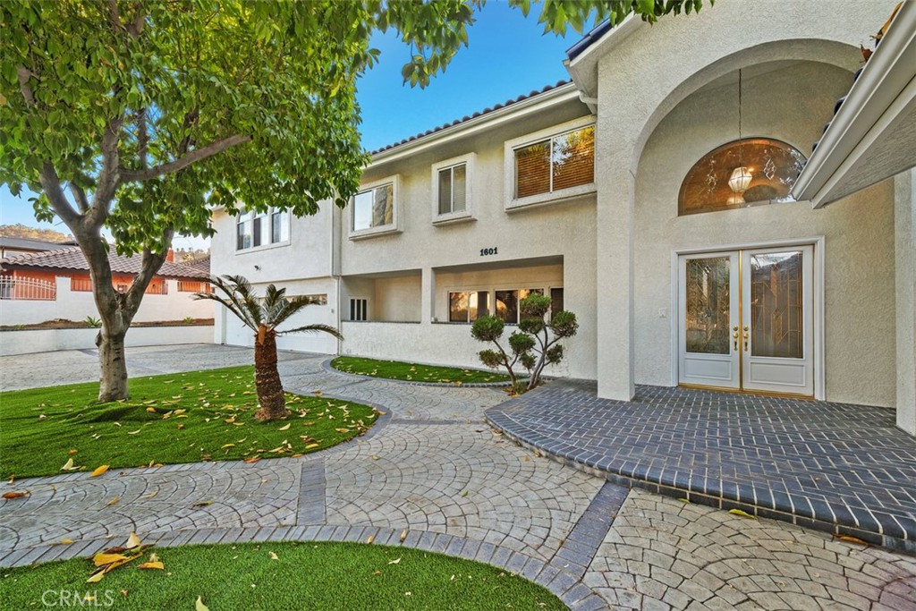 a front view of a house with garden