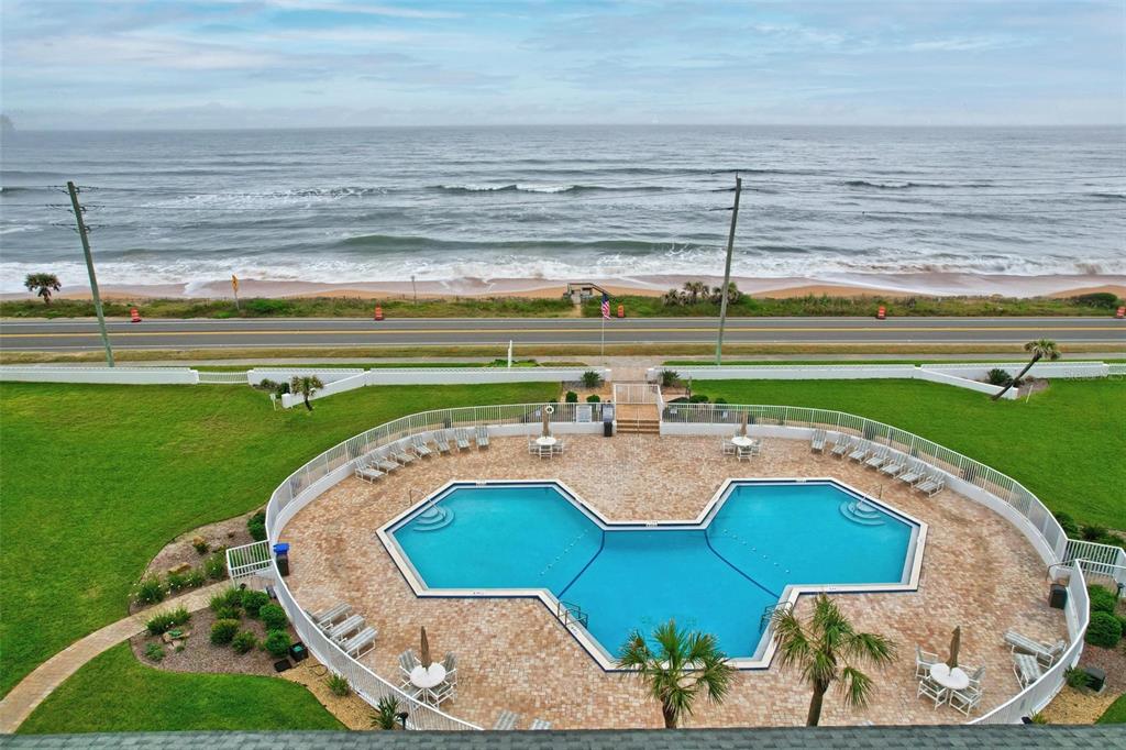 a view of a swimming pool with a yard