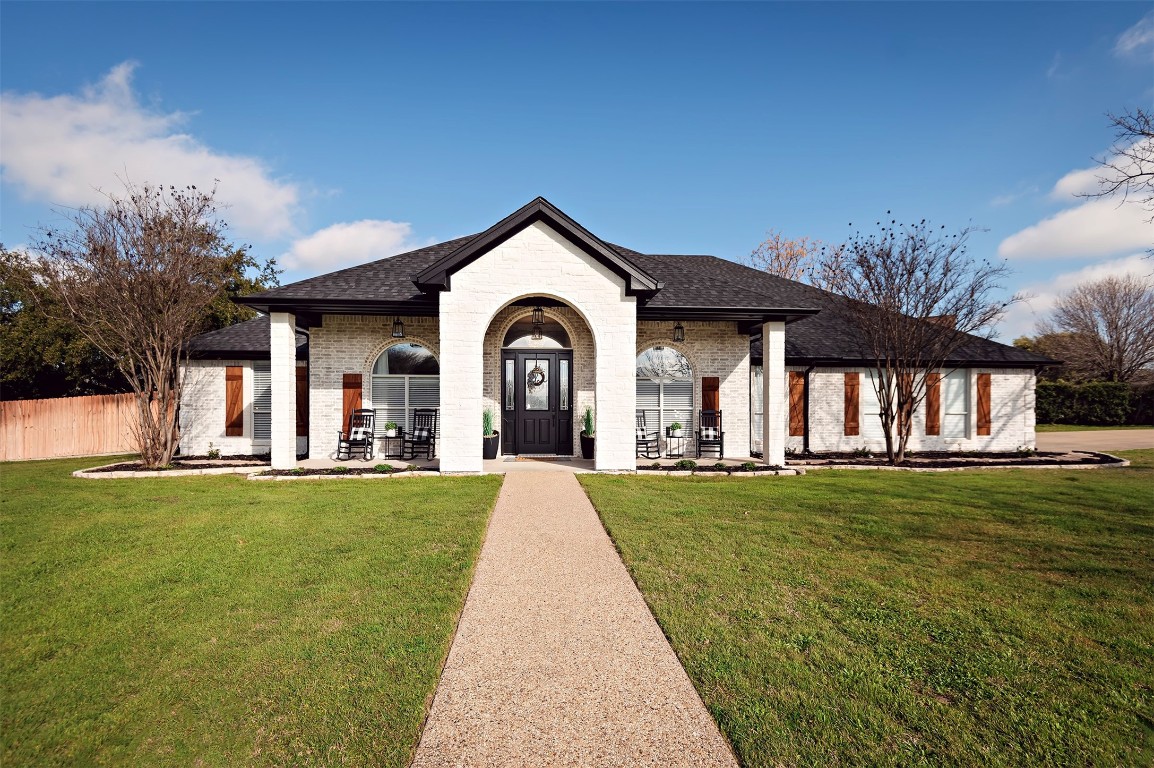 a front view of a house with swimming pool having outdoor seating