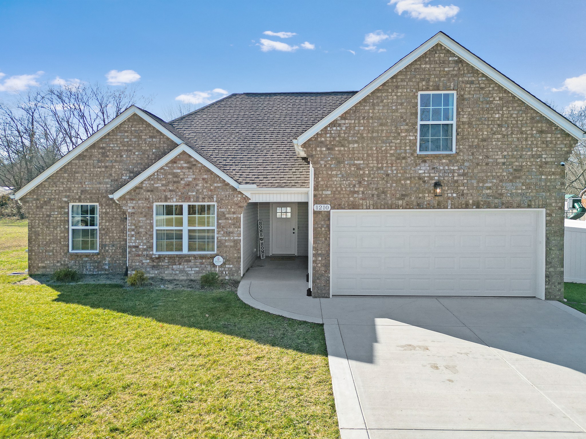 a front view of a house with a yard