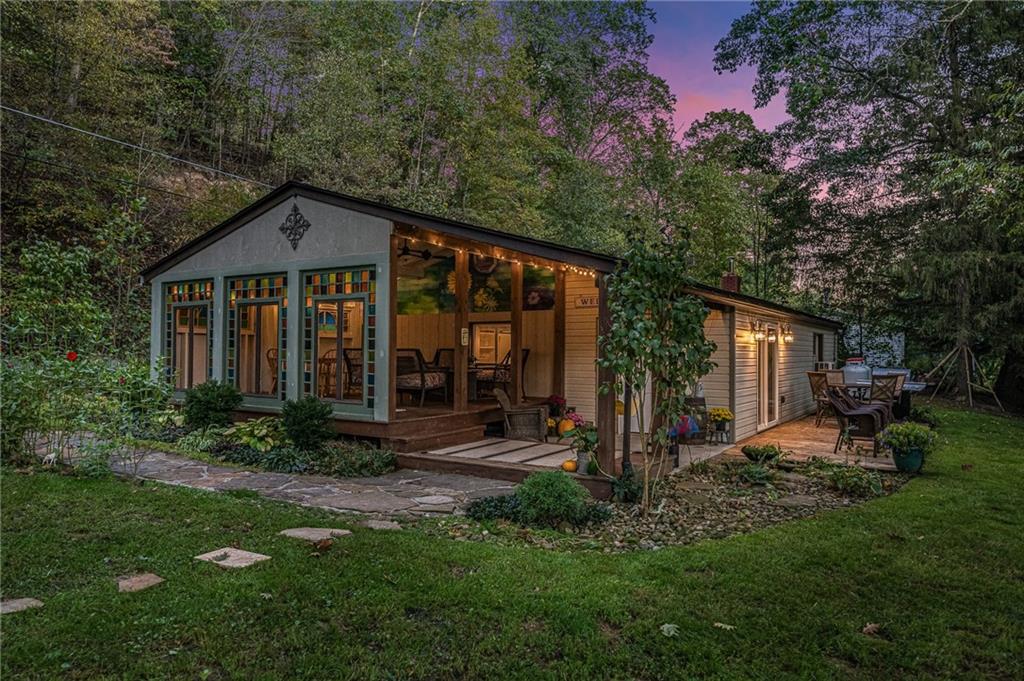 a view of a house with backyard garden and sitting area