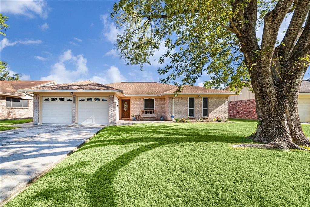 a front view of a house with a garden and yard