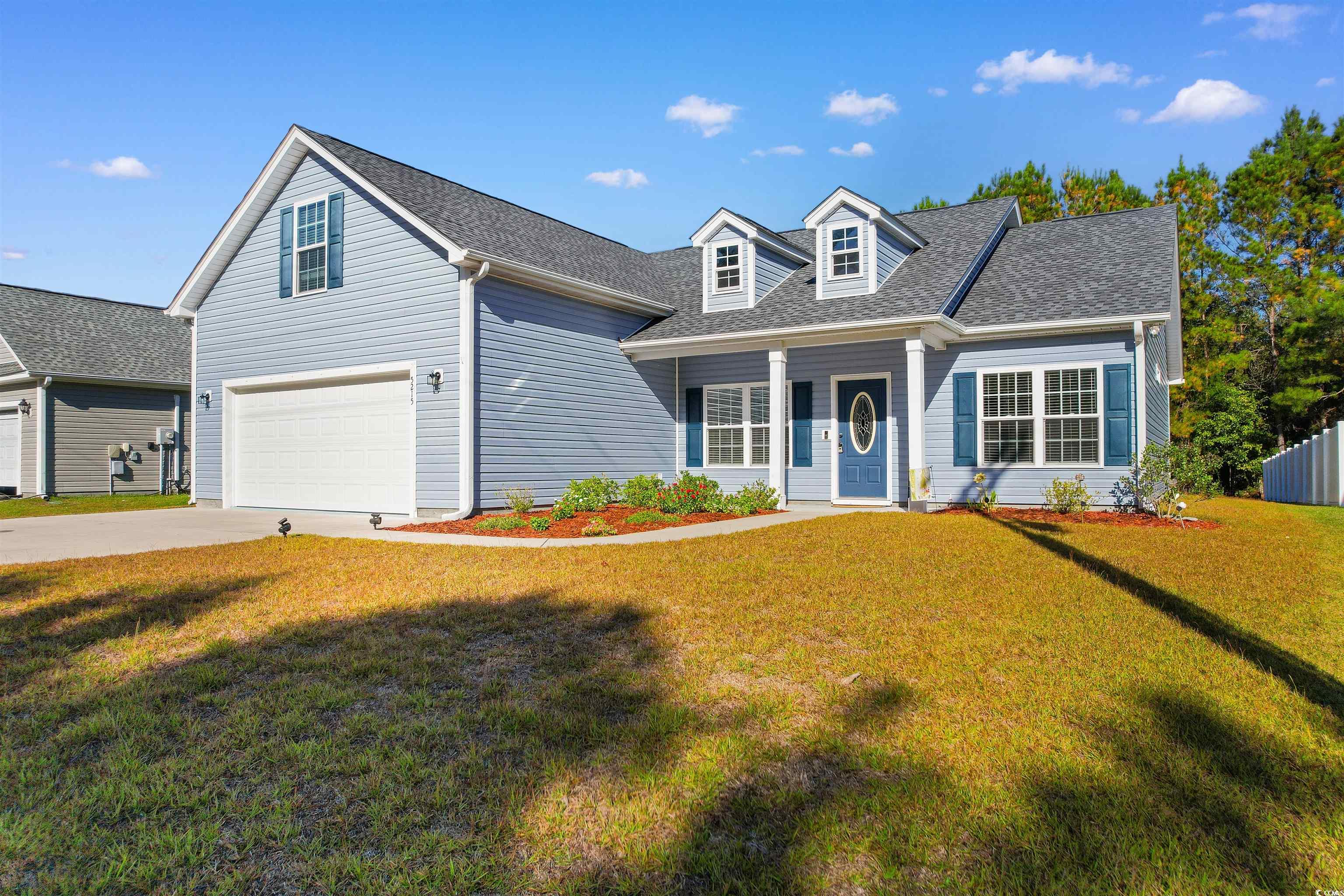 Cape cod home with a front yard and a garage