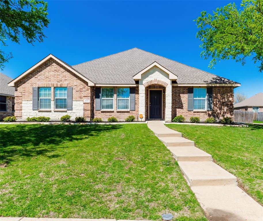 a front view of house with yard and green space