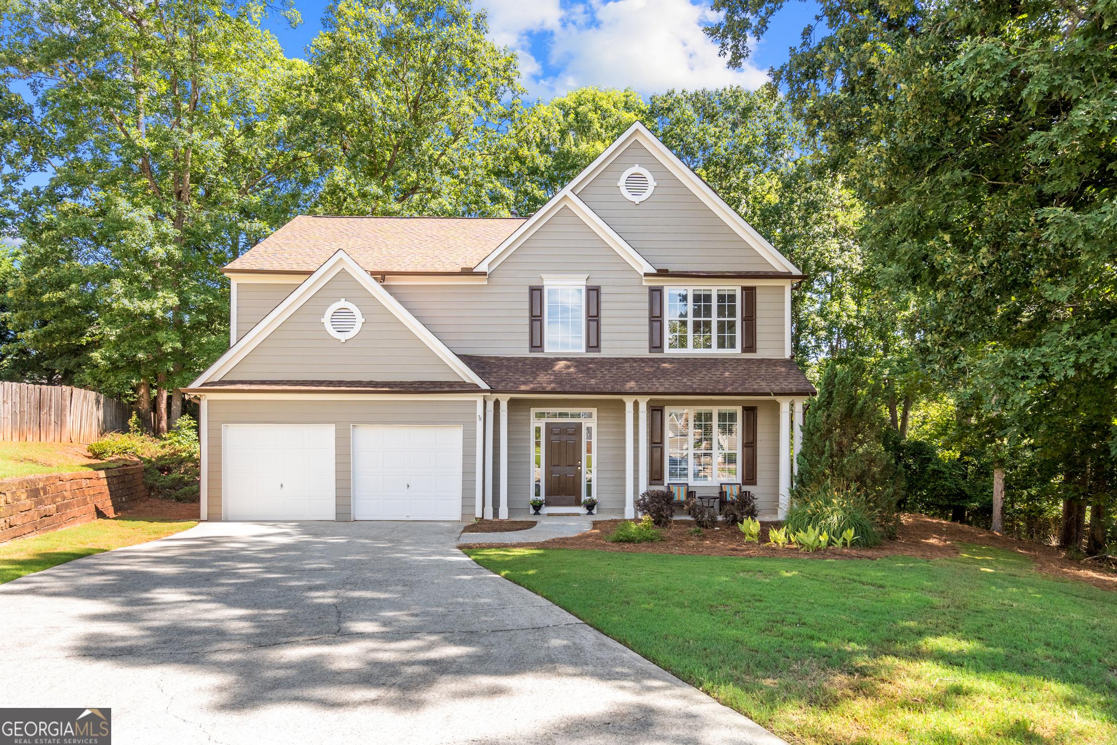 a front view of a house with a yard and garage