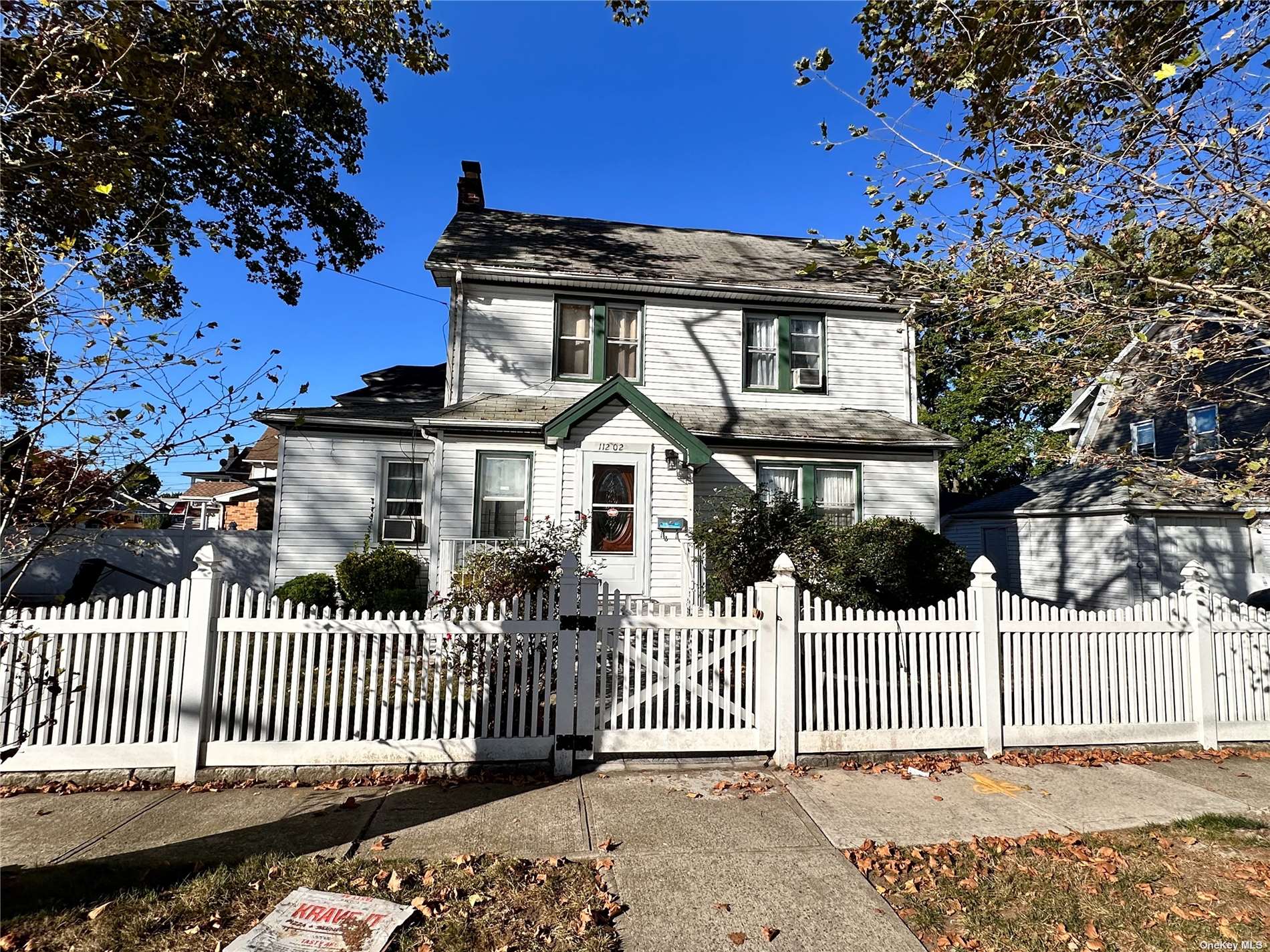 a front view of a house with a fence