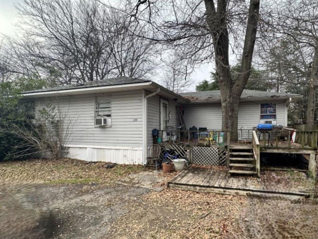 a view of a house with backyard and chairs