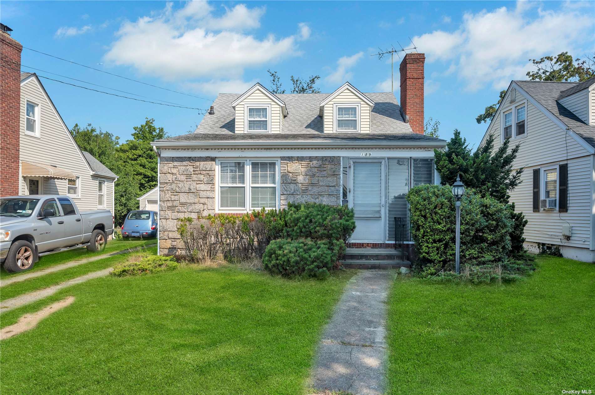 a front view of a house with a garden and plants