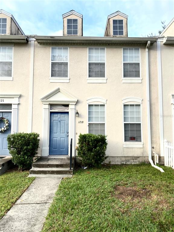 a view of a house with many windows and plants