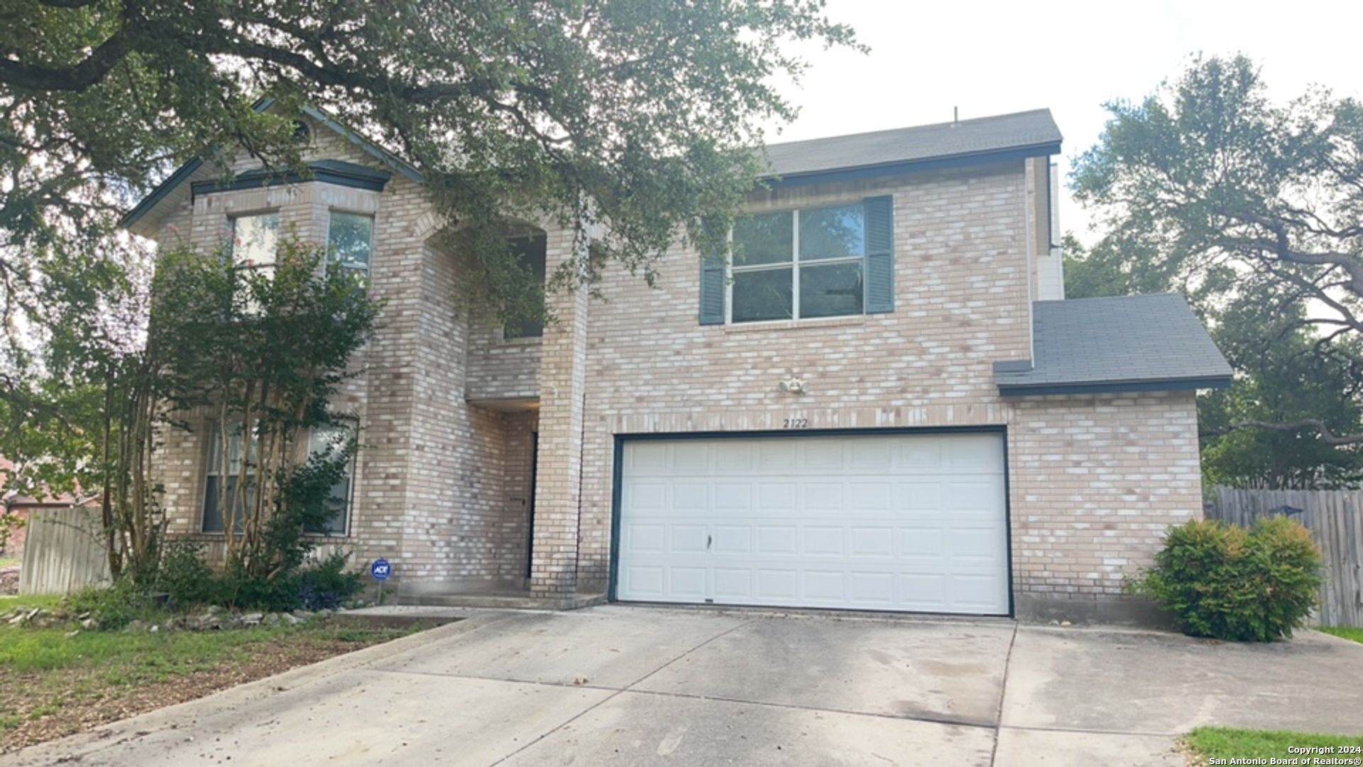 a front view of a house with garage