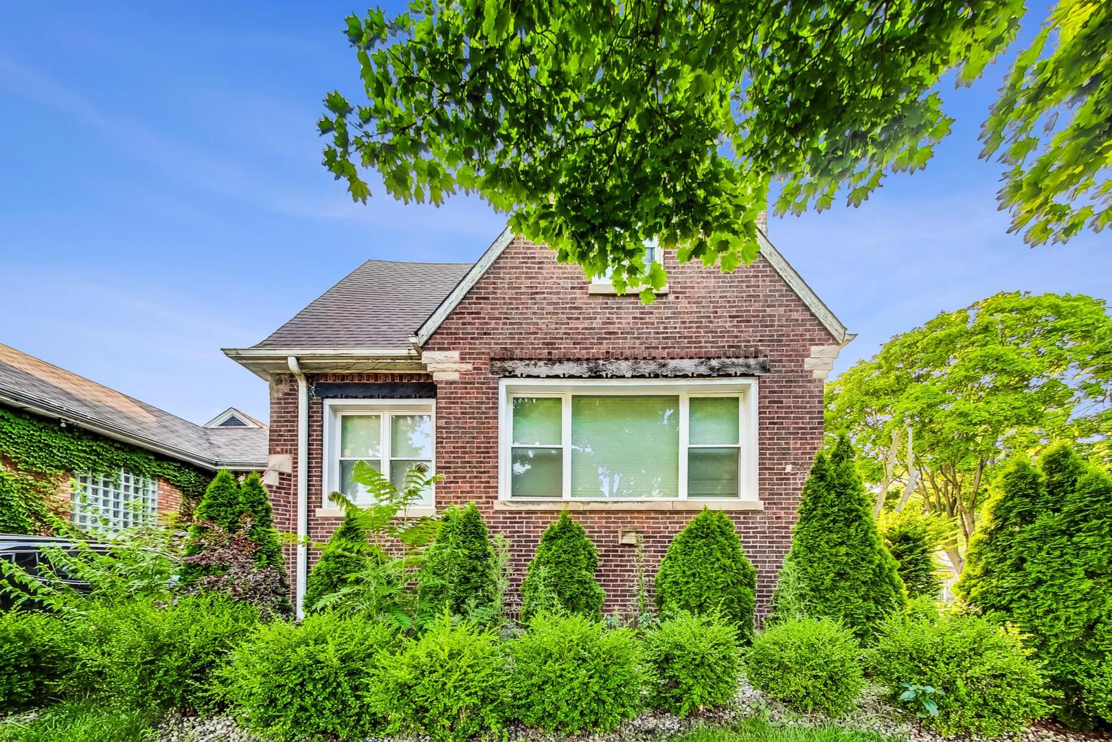 front view of a house with a tree