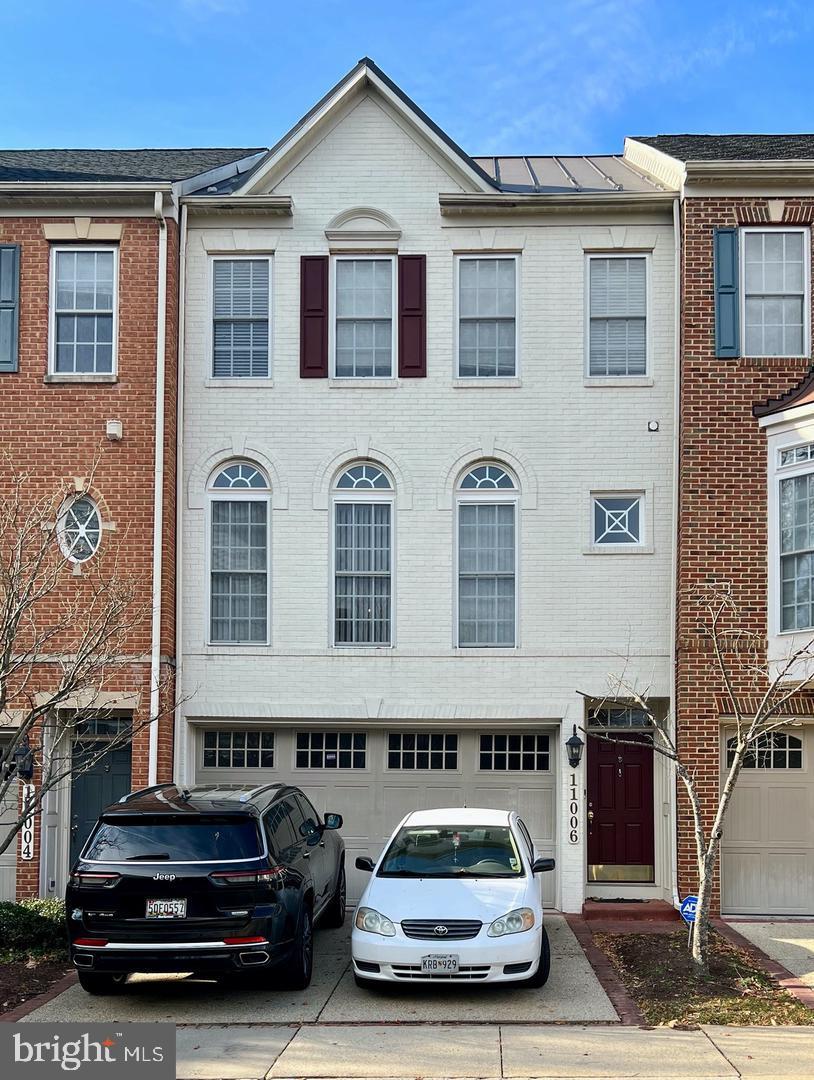 a car parked in front of a brick house