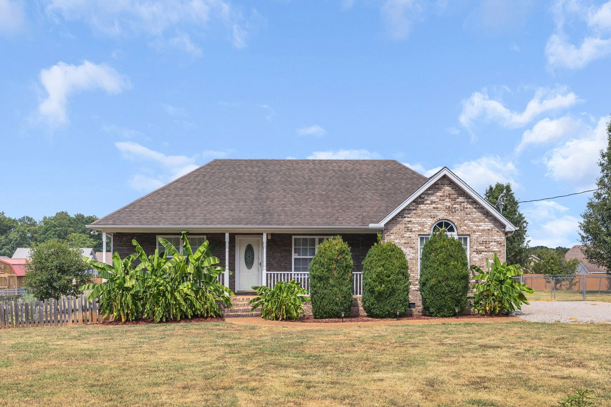 a front view of a house with a yard