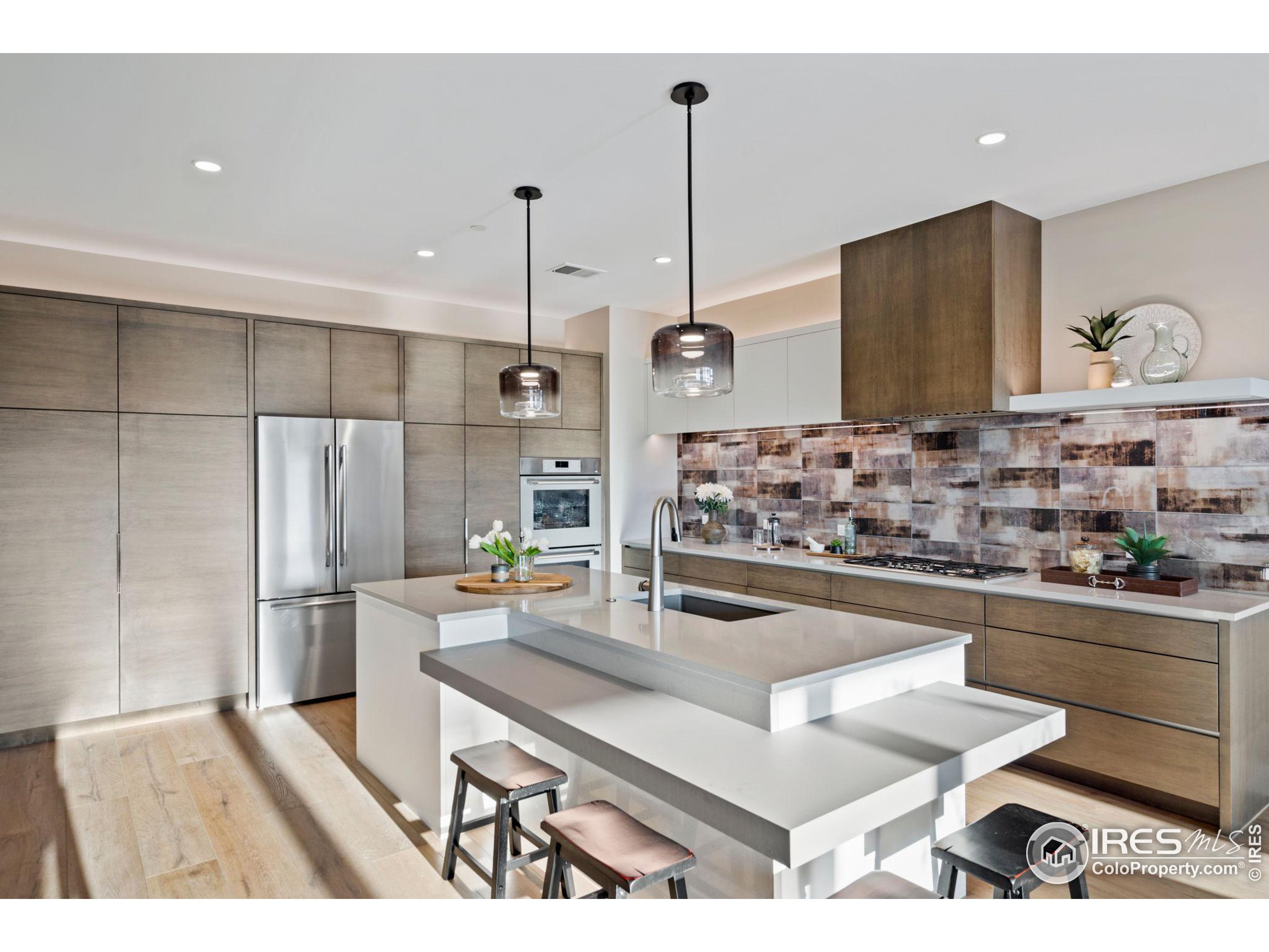 a kitchen with stainless steel appliances granite countertop a sink and a refrigerator