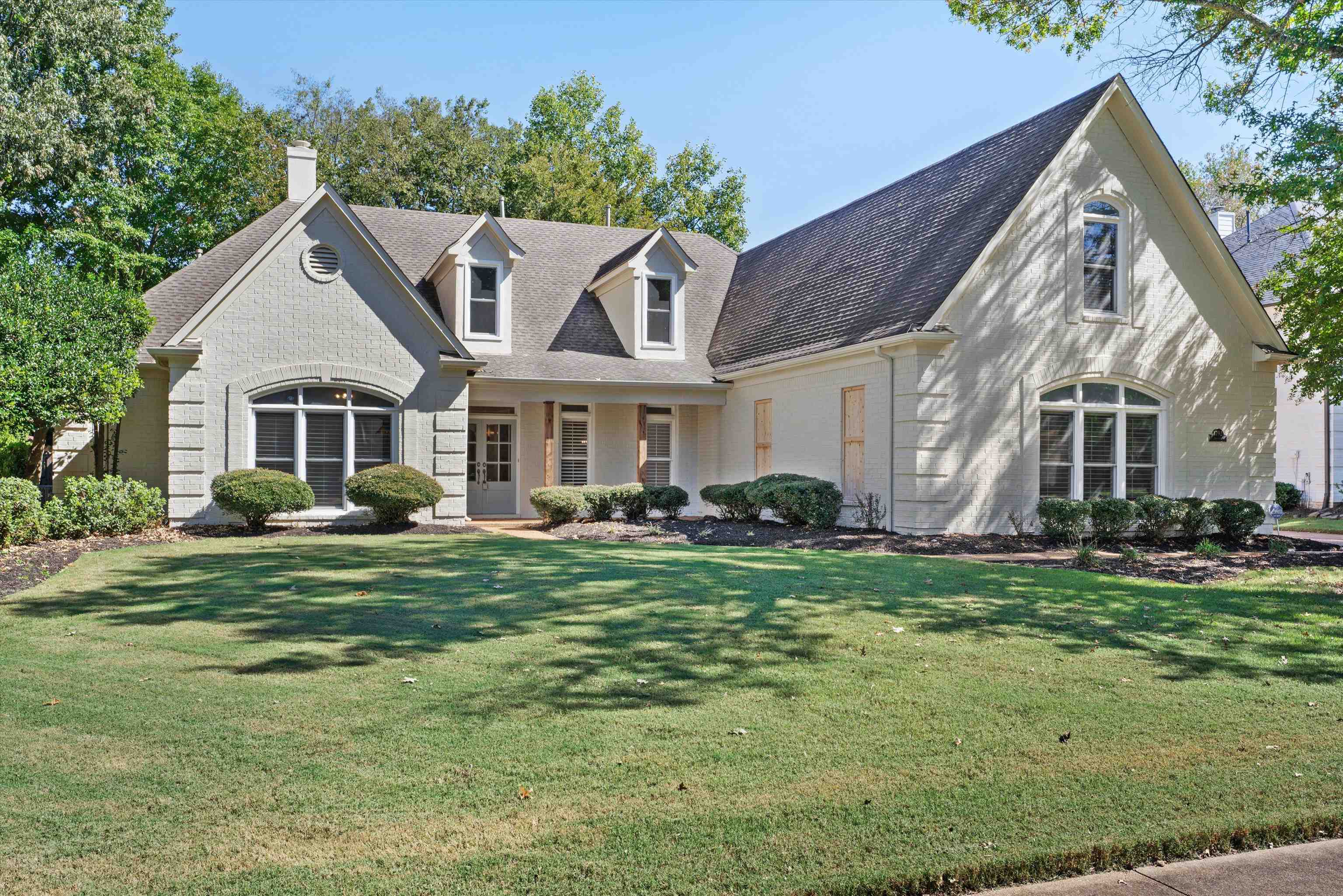 a front view of a house with a garden