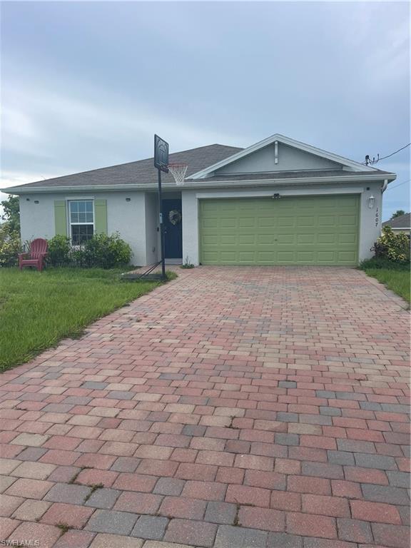 a front view of a house with a yard and garage